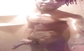 Skinny black strokes his horse cock in the shower