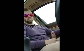 Cute guy with sunglasses jerking off in his car