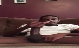 Big black dick strokes out in his living room