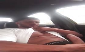 Cute horny guy stroking his cock in parking lot