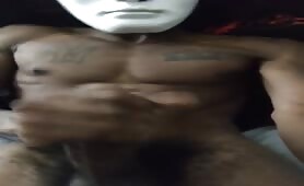 Freaky masked black guy stroking his huge beefy cock solo