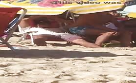 Caught a hot guy stroking his cock in public beach