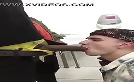 Young white boy sucks stranger black cock in public toilet