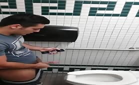 Spying a hot latino stroking his cock in public toilet