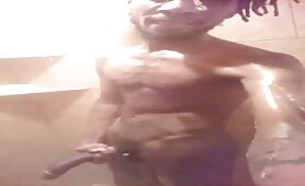 Skinny nigga strokes his horse cock in the shower