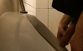 Masturbating in the public toilet while urinating