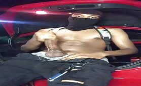 Masked thug wanking his cock in the trunk of his car