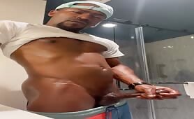 Handsome black guy rubbing his cock before taking a shower