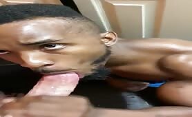 Black dude sucking off a huge pink white cock