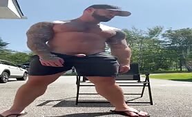 Handsome tattooed stud rubbing his huge tasty cock outdoor