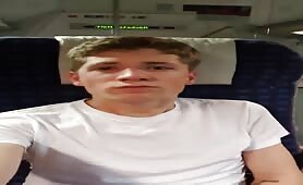 Handsome young blonde jerking off in a plane